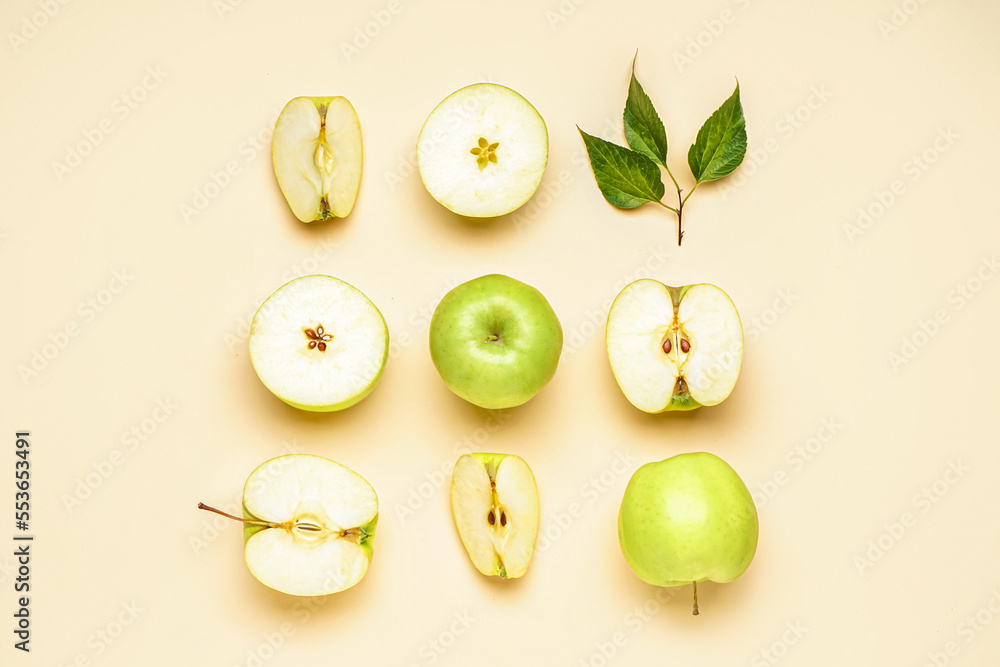 Composition with cut and whole green apples on color background Composition with cut and whole green apples on color background