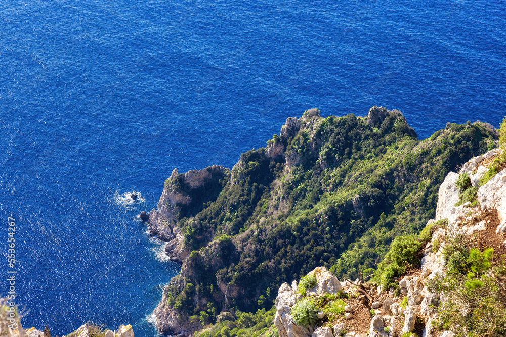 Rocky Coast by Sea at Touristic Town on Capri Island in Bay of Naples, Italy. Sunny Day. Rocky Coast by Sea at Touristic Town on Capri Island in Bay of Naples, Italy. Sunny Day.