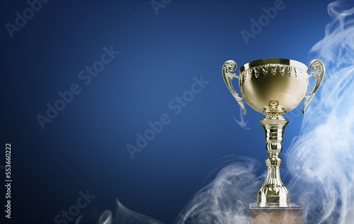 Beautiful big Trophy cup award in smoke on background photo