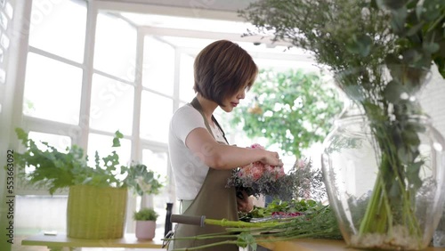 Startup successful sme small business entrepreneur owner asian woman standing table with flowers at florist shop service job. Portrait of asian girl successful owner environment friendly banner