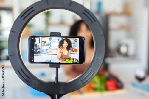 Vlogging and freelance job concept. food blogger preparing food. cooking and culinary skills concept. Young woman shooting video using camera on tripod.