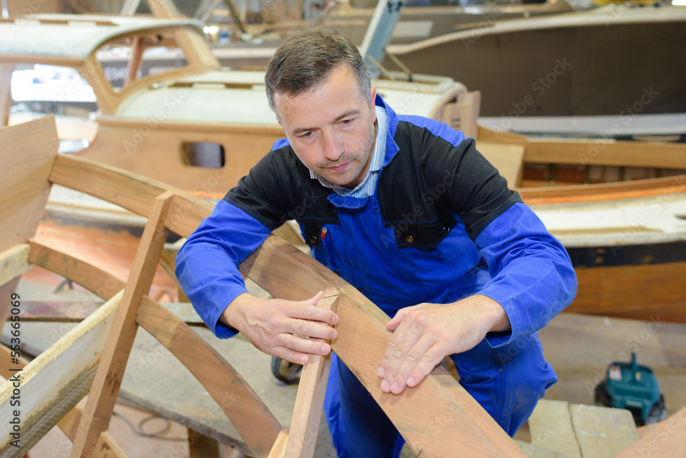 a man is making wooden boat a man is making wooden boat