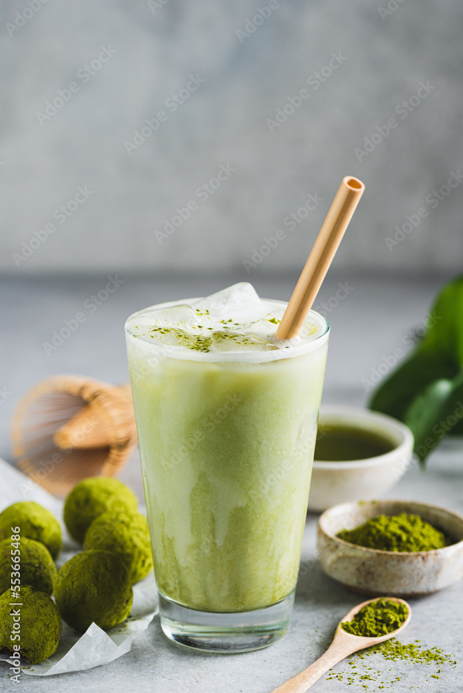 Cold Matcha Latte Ice In Glass With Bamboo Drinking Straw. Healthy Vegan Drink, Coffee Alternative. Copy Space Cold Matcha Latte Ice In Glass With Bamboo Drinking Straw. Healthy Vegan Drink, Coffee Alternative. Copy Space