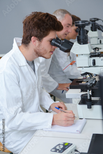 student in biology using microscope in training class