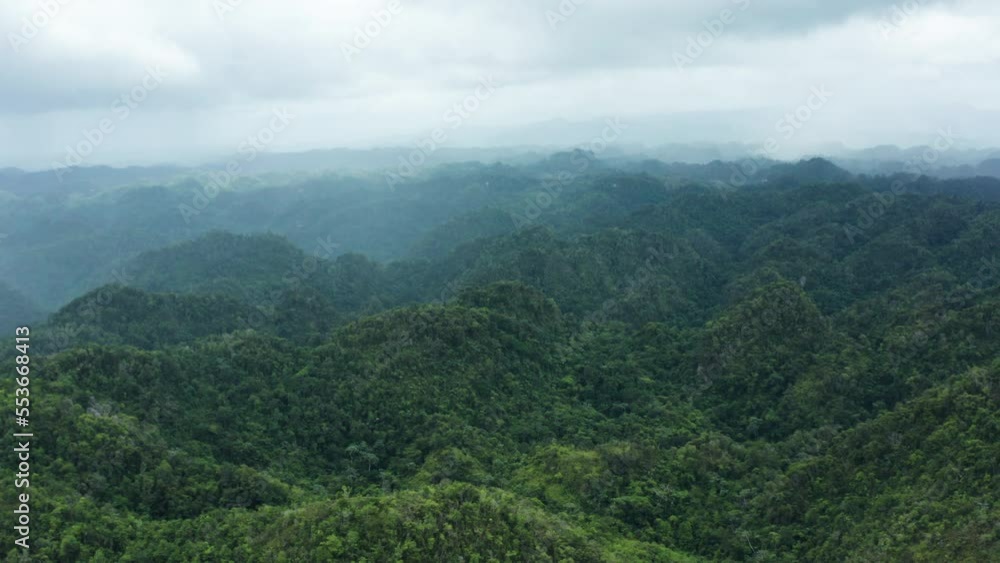 Rainfall and clouds cover dense jungle mountain tops in Puerto Rico wilderness Rainfall and clouds cover dense jungle mountain tops in Puerto Rico wilderness