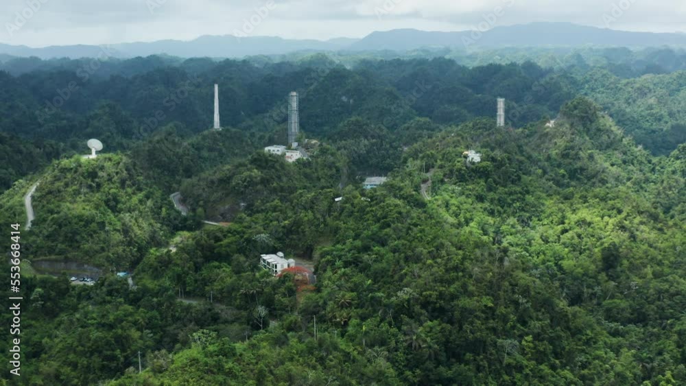 Slow zoom out of Arecibo Observatory, antenna dishes and towers in