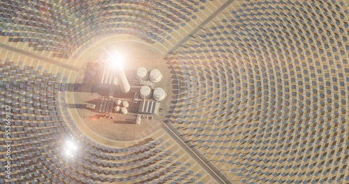 Solar thermal power plant. Renewable energy production. Solar energy. Aerial view of central power plant and industrial facilities surrounded by many reflecting mirrors. Sun moving. 3D rendering.