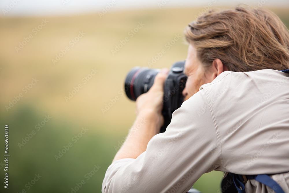 young man taking a photo on the nature young man taking a photo on the nature