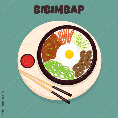 Korean traditional food cuisine dish bibimbap on the wooden cutting board. Top view.