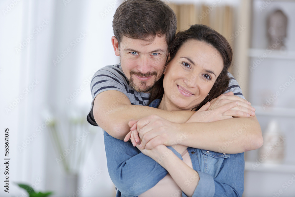 Fototapeta premium loving couple is hugging indoors