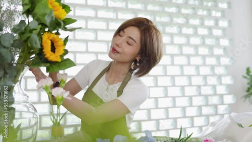 Startup successful sme small business entrepreneur owner asian woman standing table with flowers at florist shop service job. Portrait of asian girl successful owner environment friendly banner