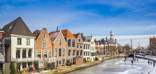 Panorama of historic houses at the frozen canals of Dokkum, Netherlands