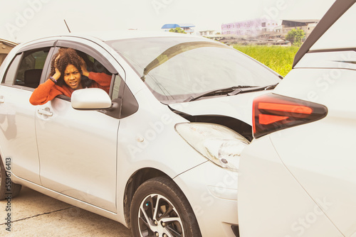 Photography African American young woman shocked driving at high speed and failing to brake Driving recklessly until hitting the back of the car and damaging the front, open the car door and look at the damage