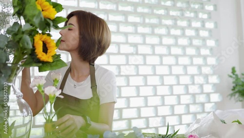 Startup successful sme small business entrepreneur owner asian woman standing table with flowers at florist shop service job. Portrait of asian girl successful owner environment friendly banner