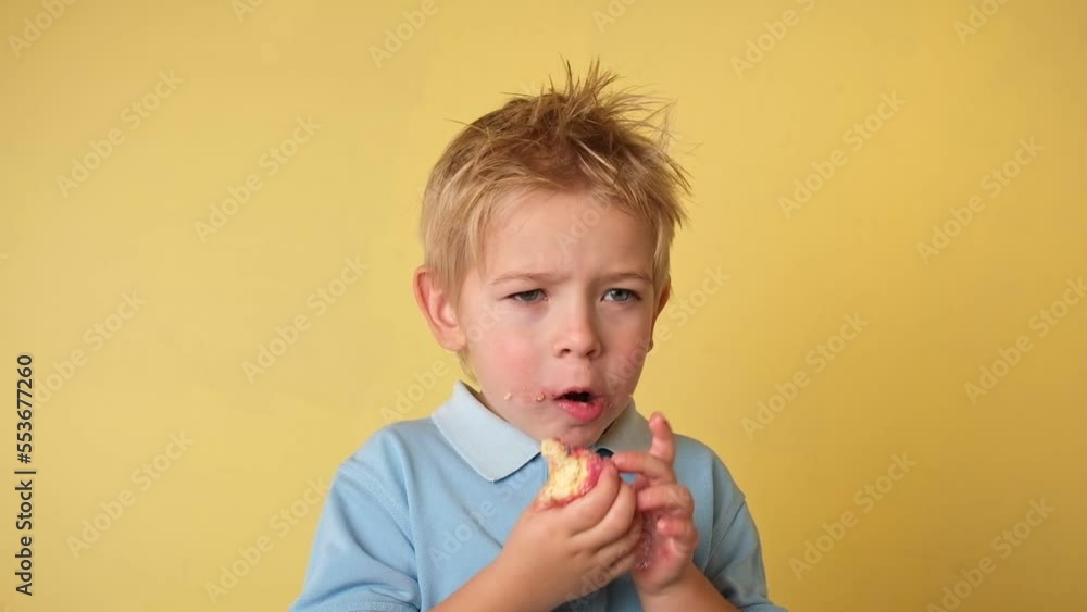 Happy Child holding glazed donut. Little boy is covering eyes donuts on yellow studio background. Kid is having fun with donut. Tasty sweet food for kids. Holiday, Birthday, Party Concept. Yummy. Happy Child holding glazed donut. Little boy is covering eyes donuts on yellow studio background. Kid is having fun with donut. Tasty sweet food for kids. Holiday, Birthday, Party Concept. Yummy.
