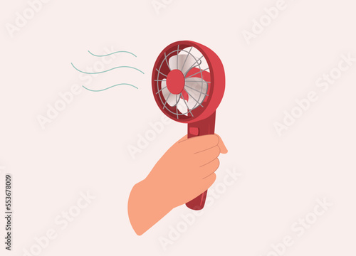 A Person’s Hand Holding A Mini Electric Portable Fan With Wind Blowing. Close-Up. Flat Design Style, Character, Cartoon.