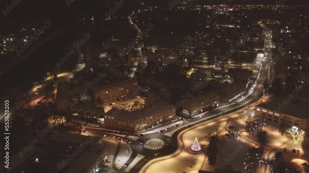 A night drone flight over an illuminated city.The city of Valmiera from above in winter A night drone flight over an illuminated city.The city of Valmiera from above in winter