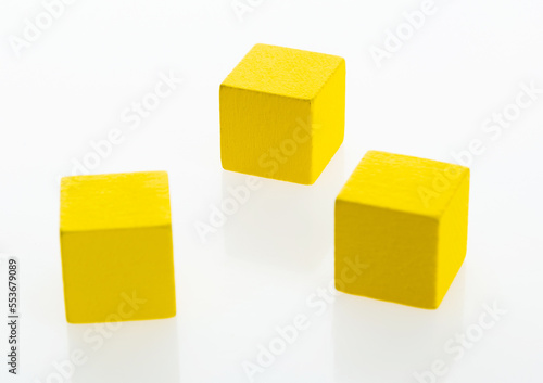 Three yellow wooden blocks on white background © xy