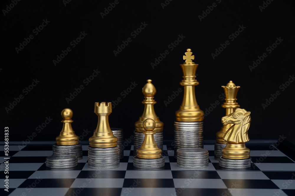 Gold Chess with Coins. Chess with piles of coins on the board. Plan the use of money. Money game concept. Copy space. Gold Chess with Coins. Chess with piles of coins on the board. Plan the use of money. Money game concept. Copy space.