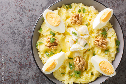 Cuadro en lienzo Atascaburras typical dish of Spanish Castilian La Mancha potato, cod, egg and walnuts closeup on the bowl on the table