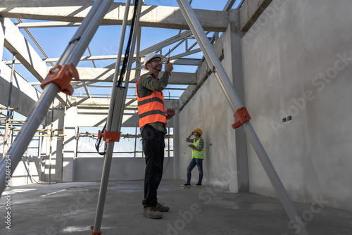 Engineer Construction man checking building project in construction site © Jack Tamrong