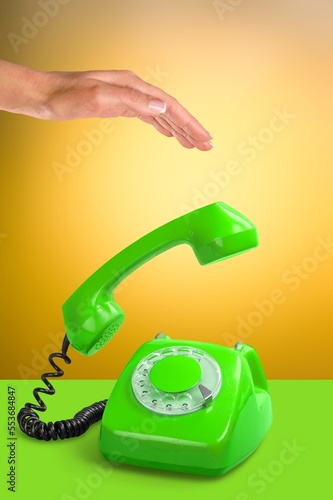 Colorful old retro phone and female hand