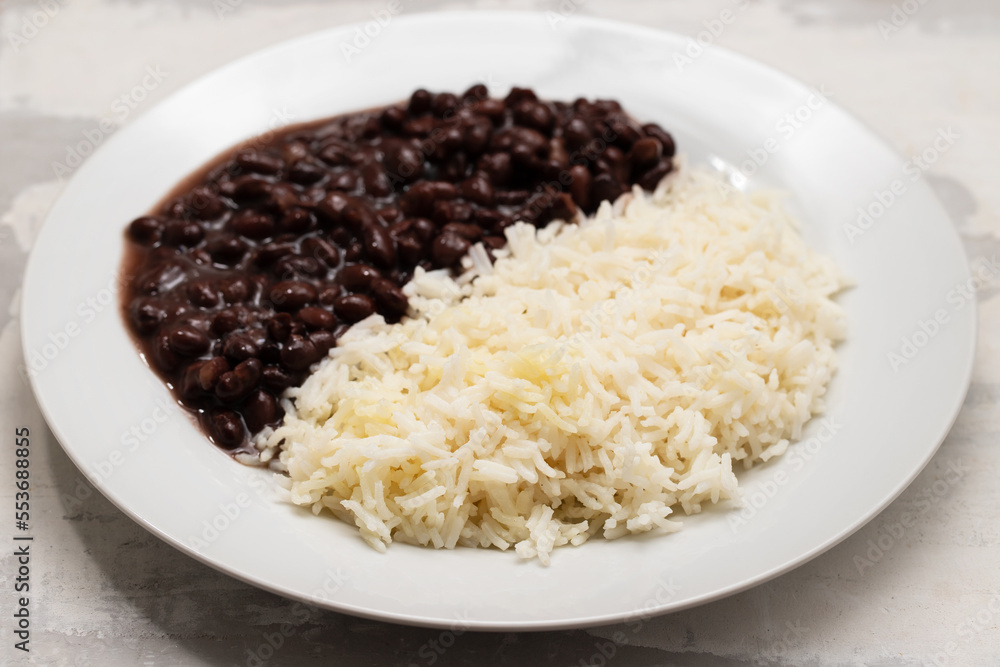 Black beans and boiled rice on white dish. Black beans and boiled rice on white dish.