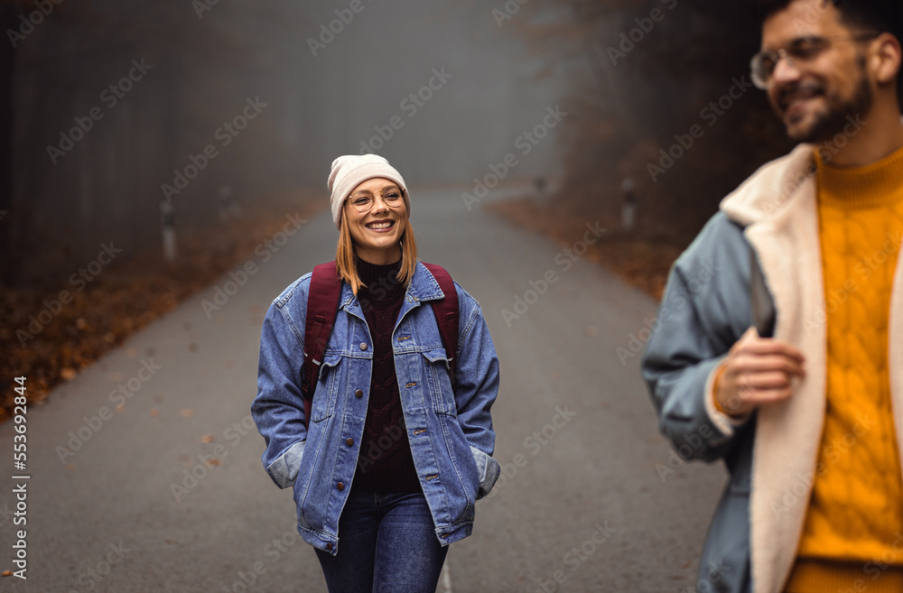Couple spending time together walking on forest road on a foggy morning. Couple spending time together walking on forest road on a foggy morning.