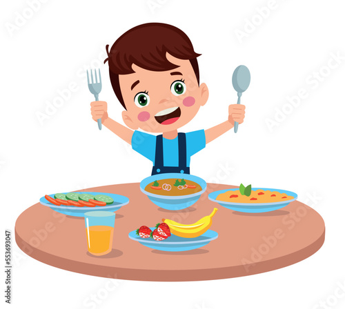 cute little boy eating at the dinner table