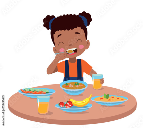 cute little boy eating at the dinner table