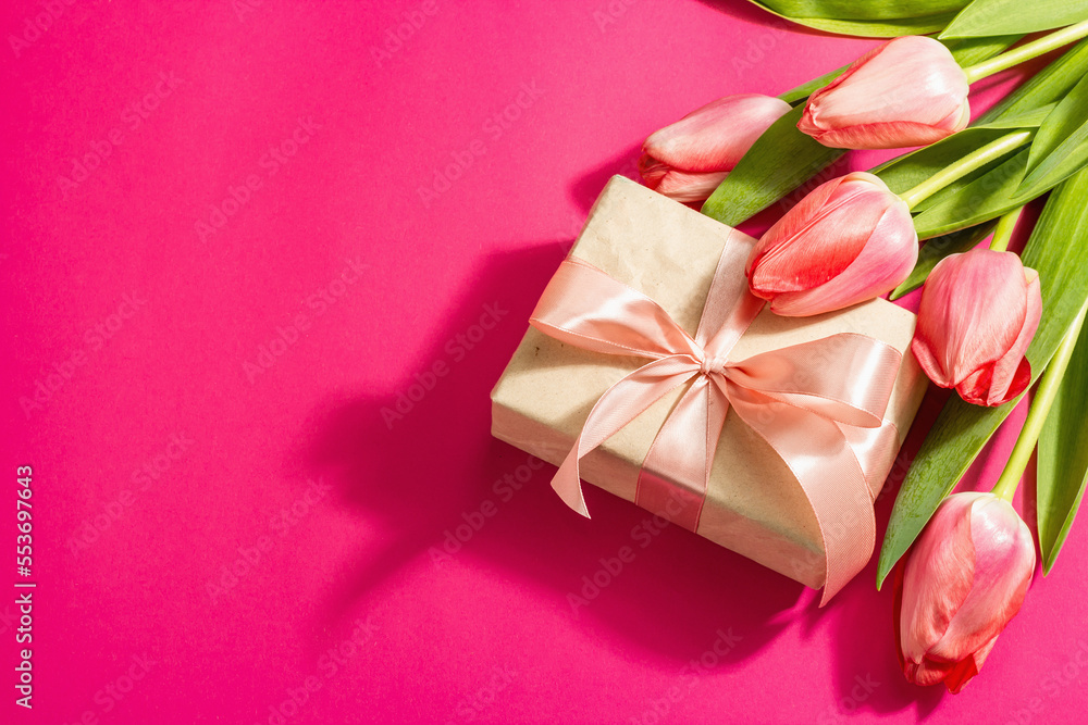 Greeting concept flower composition, a bouquet of pink tulips, and a gift. Greeting concept flower composition, a bouquet of pink tulips, and a gift.