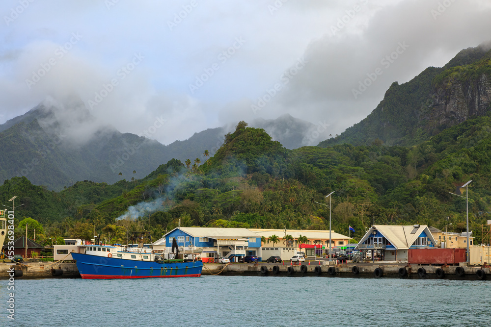 The port pf Avarua, the main town on the tropical island of Rarotonga, Cook Islands. In the background are the island's mountains, shrouded in cloud