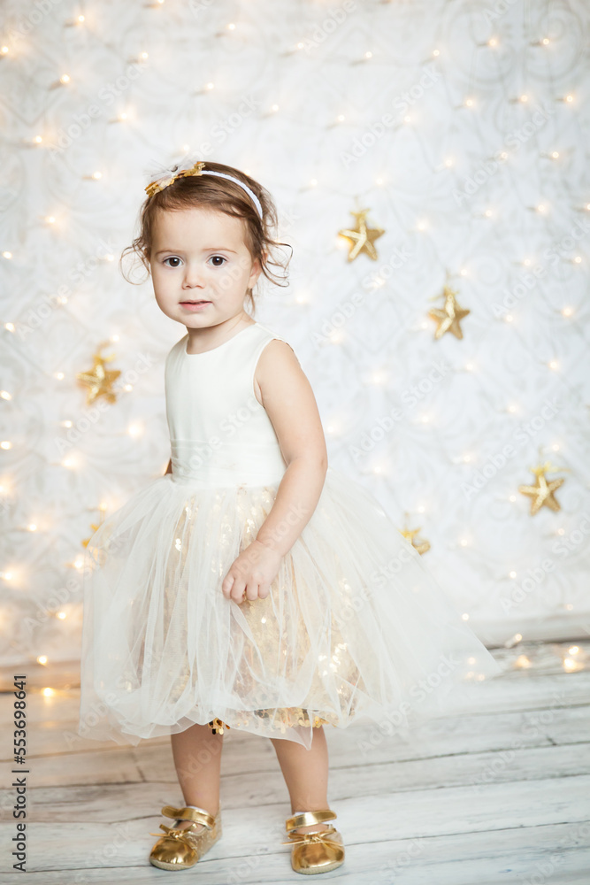 cute baby girl in a white and gold dress cute baby girl in a white and gold dress