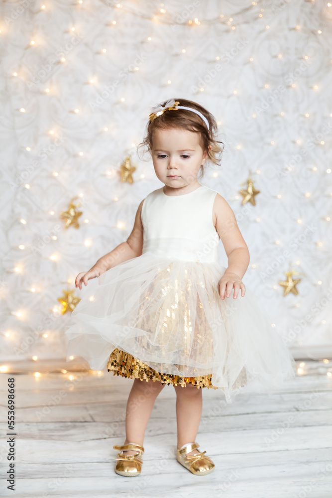 cute baby girl in a white and gold dress cute baby girl in a white and gold dress