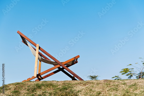 Fotografiet Deck chair on the meadow in the garden