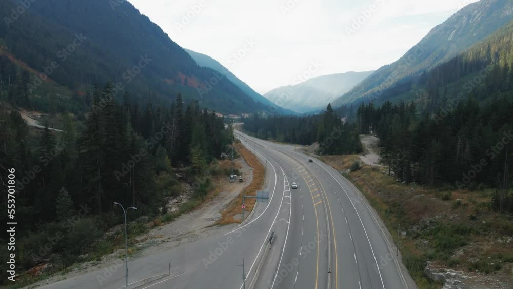 Cars driving on the Coquihalla Highway 5 in British Columbia Canada on a sunny day in the fall Cars driving on the Coquihalla Highway 5 in British Columbia Canada on a sunny day in the fall