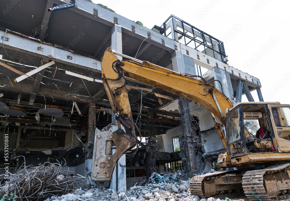 Excavator working on building demolition site Excavator working on building demolition site