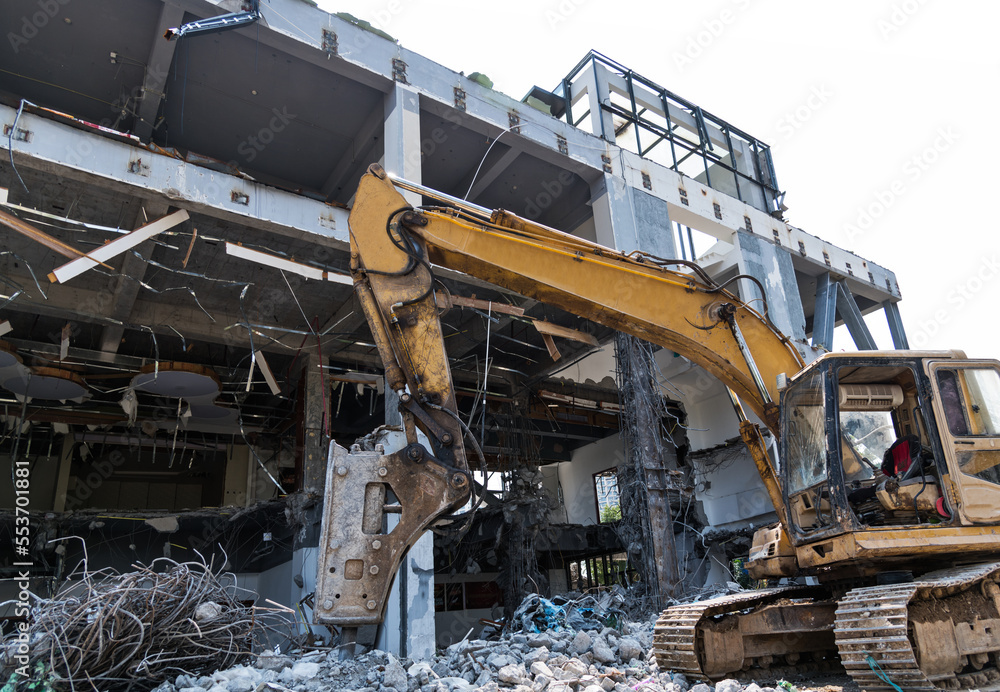 Excavator working on building demolition site