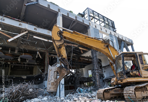 Excavator working on building demolition site