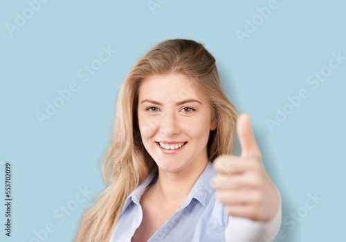 Wallpaper Mural Young happy woman show a finger Torontodigital.ca