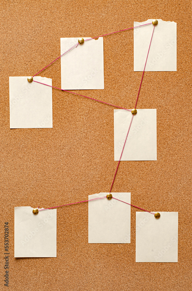 Blank paper notes are pinned to a cork board. The concept of detective investigation. Copy space. Blank paper notes are pinned to a cork board. The concept of detective investigation. Copy space.