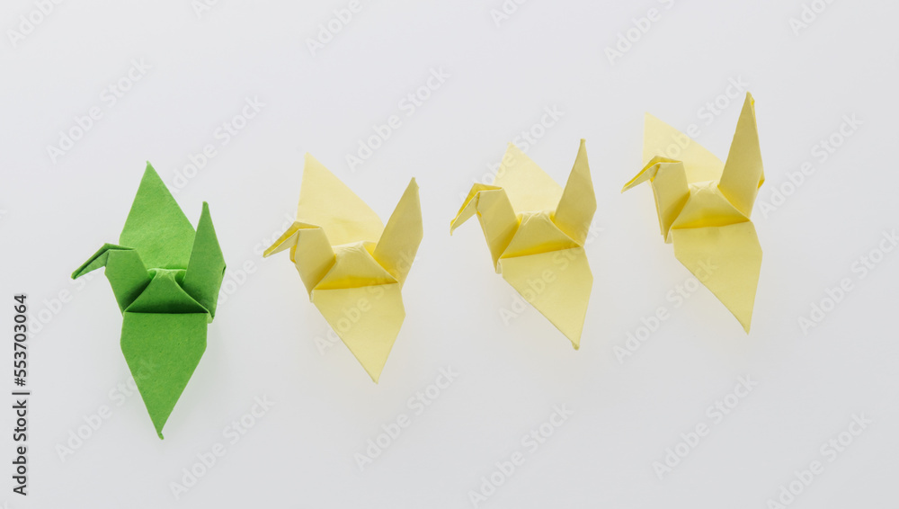 A row of paper cranes on white background A row of paper cranes on white background