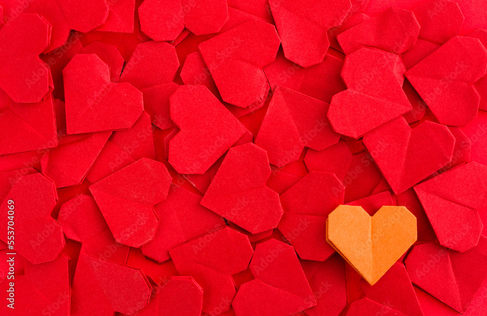 Obraz premium Orange origami heart on red origami hearts