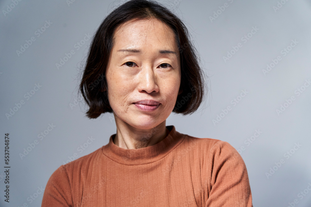 Serious mature Asian woman looking at the camera Serious mature Asian woman looking at the camera