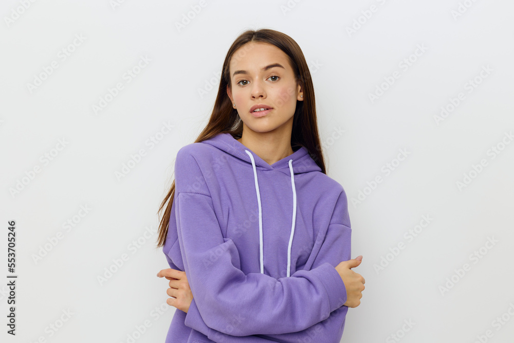 a relaxed woman stands on a white background in a purple suit calmly looks forward with her mouth slightly open and her arms crossed in front of her a relaxed woman stands on a white background in a purple suit calmly looks forward with her mouth slightly open and her arms crossed in front of her