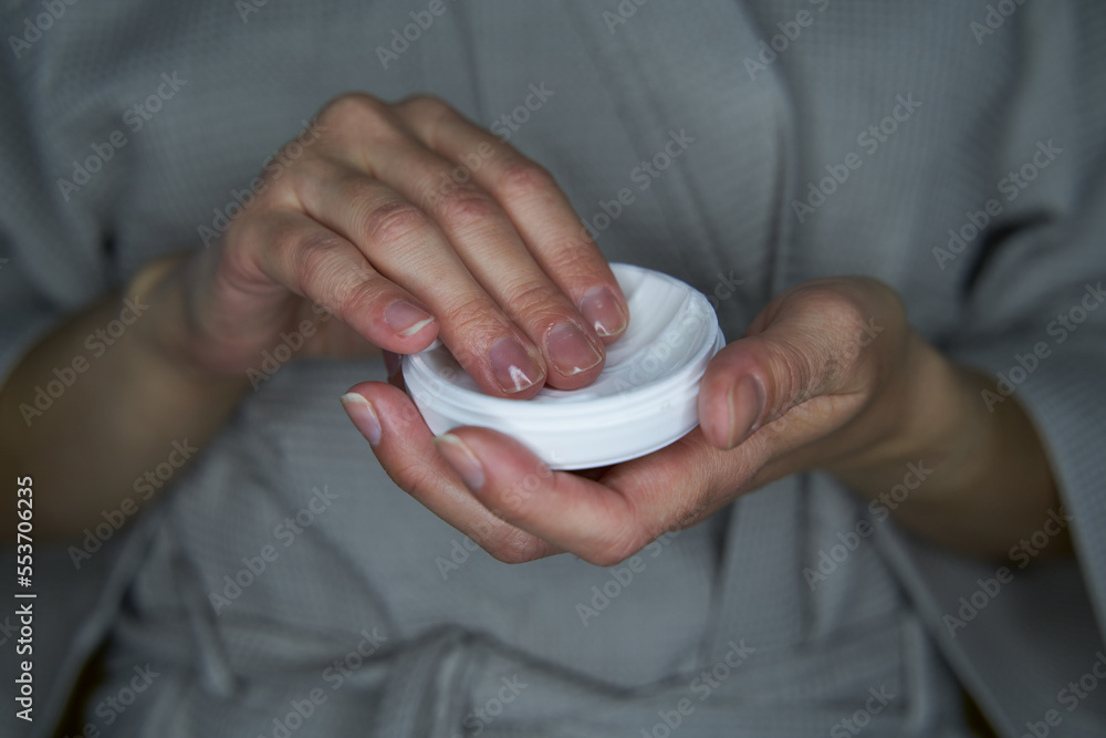 Woman with a jar of cream in her hands Woman with a jar of cream in her hands