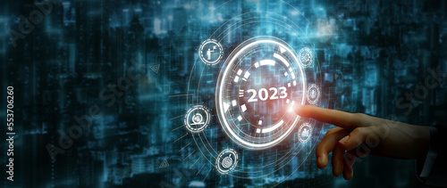 2023 automation technology and business transformation, adaptation, changing concept. Transform business model and automation strategy for thriving business. Finger about to press a button with 2023.