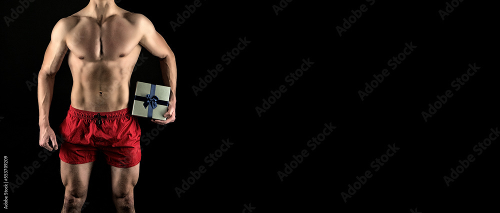 man with muscular torso hold present. muscular man with present box. present from man