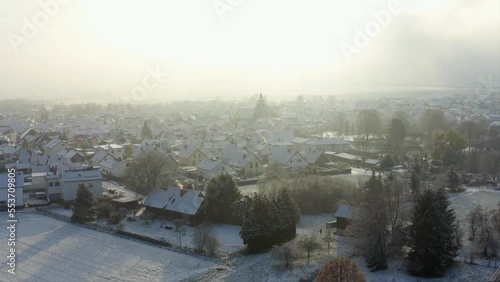 Cinematic Aerial Drone Shot of Komturkirche in Butzbach Germany covered in Snow photo