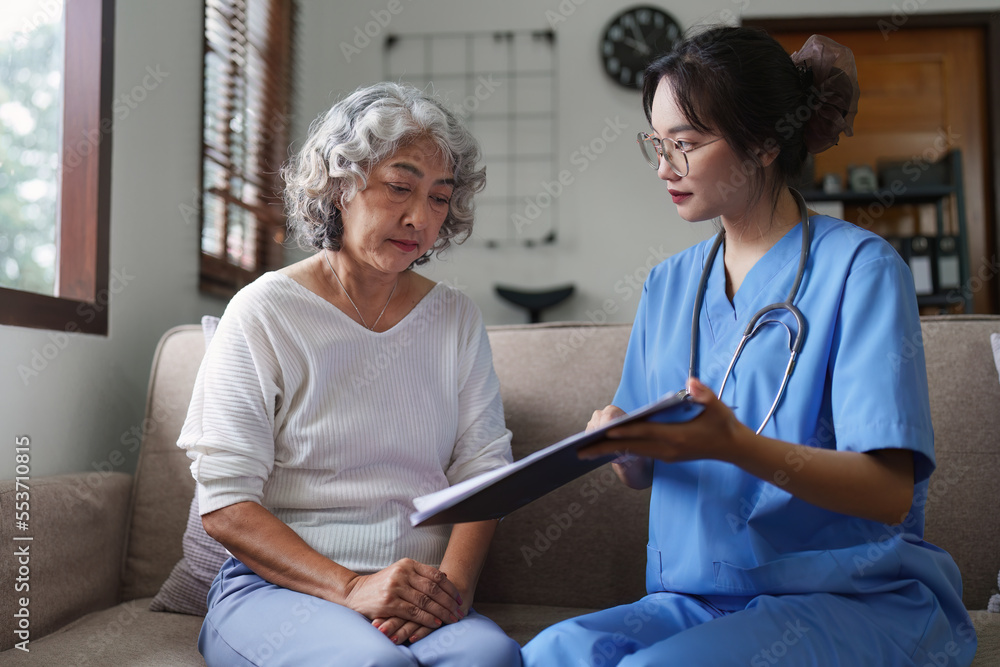 Fototapeta premium Asian youthful nurse caring for patients or the elderly at home. nursing at home concept
